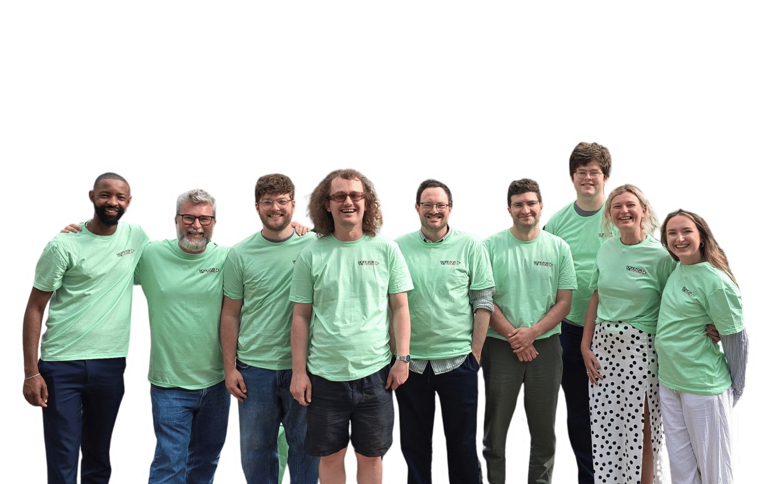 Nine people stand smiling in green t-shirts