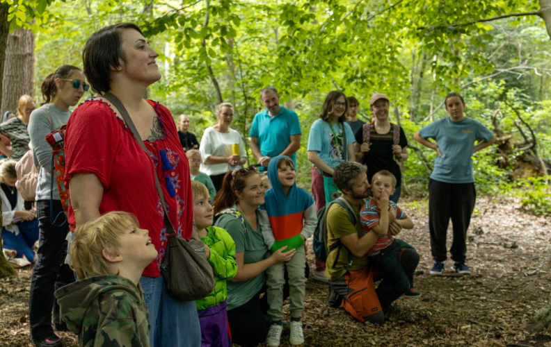 Families gather in the forest for 'A Future for All' event.
