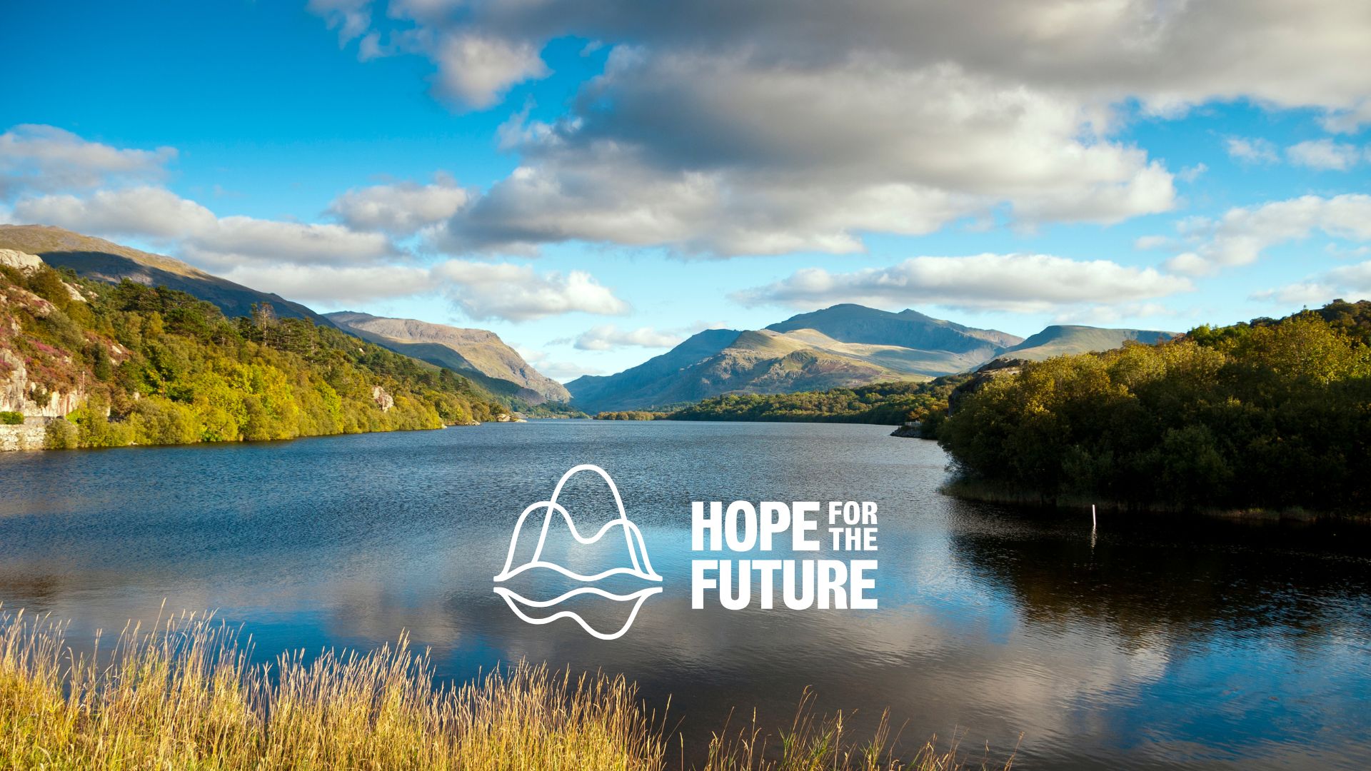 An image of a lake in Snowdonia, with Hope for the Future's logo in the bottom middle